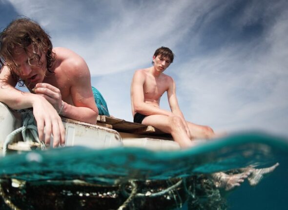 Two,Men,Floating,In,A,Sea,With,Sad,Faces